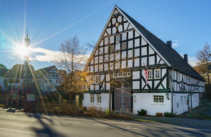 Half-timbered house of the hiking portal in the health resort of Cobbenrode in autumn sunshine